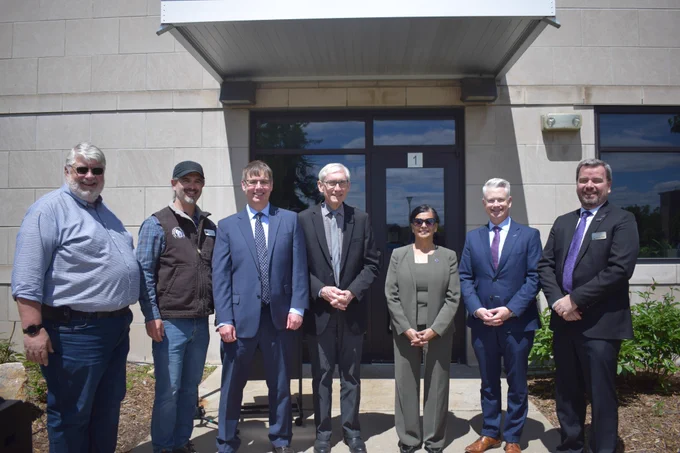 Gov. Evers poses for a group photo with UW Stevens Point leadership and local leaders. 
