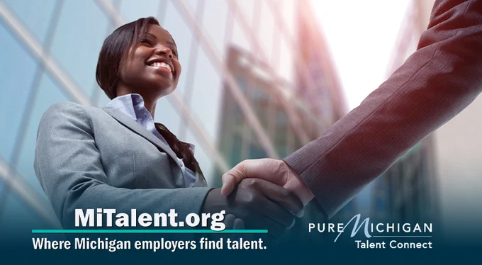 Black woman in a business suit shaking hands with someone off screen. Text on image says, "MiTalent.org, where Michigan employers find talent."