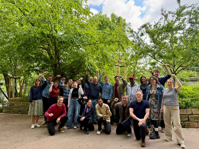 Photo of a group of people with their fists raised.