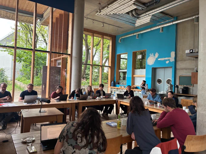 Photo of a group of people discussing in a roundtable.