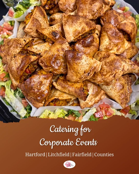 Corporate catering appetizer platter from Simply Chef Renée featuring golden-brown baked savory pastries served over fresh lettuce and diced tomatoes. Catering tray designed for office lunches, networking events, team celebrations, and corporate events in Hartford, Litchfield, and Fairfield Counties, Connecticut.