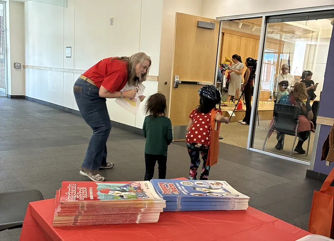 Woman reads to children in a library