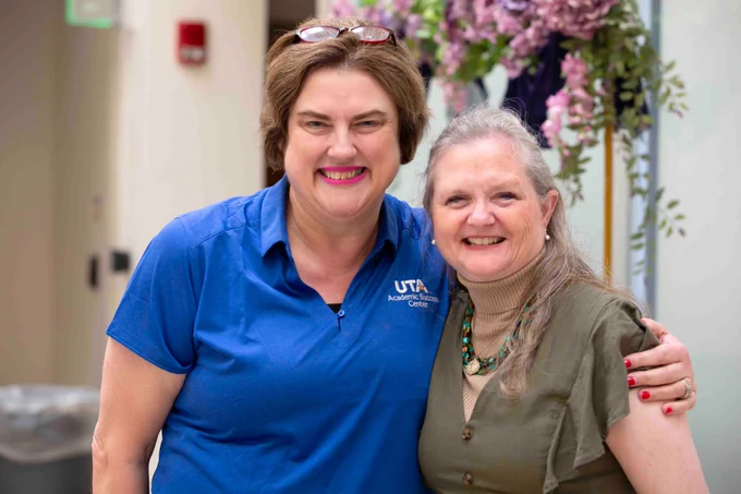 Pictured is a photo of UTA Libraries staff member Antoinette Nelson posing for a photo at her retirement party.