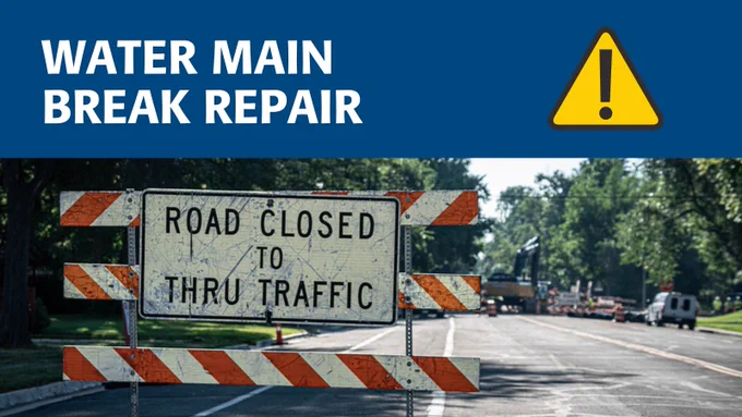 Water main break repair in progress. Photo of a road closure sign.