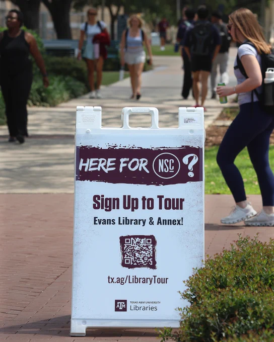 Sign that says Here for NSC? Sign Up to Tour Evans Library & Annex! tx.ag/LibraryTour