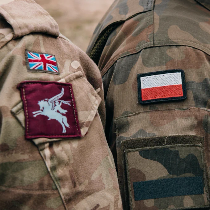 National badges on the uniform of British and Polish troops next to each other  during Exercise Swift Response on the 7th of May 2024.