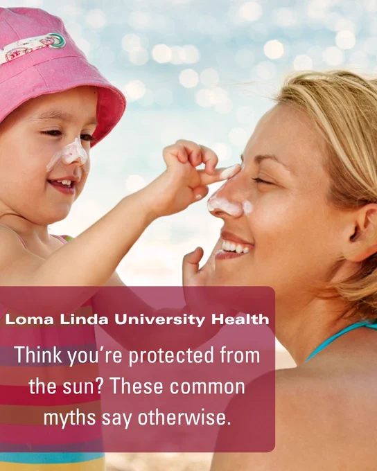 A young girl applies sunscreen to a woman's nose at the beach. Both are smiling. Text overlay reads, "Loma Linda University Health. Think you're protected from the sun? These common myths say otherwise.