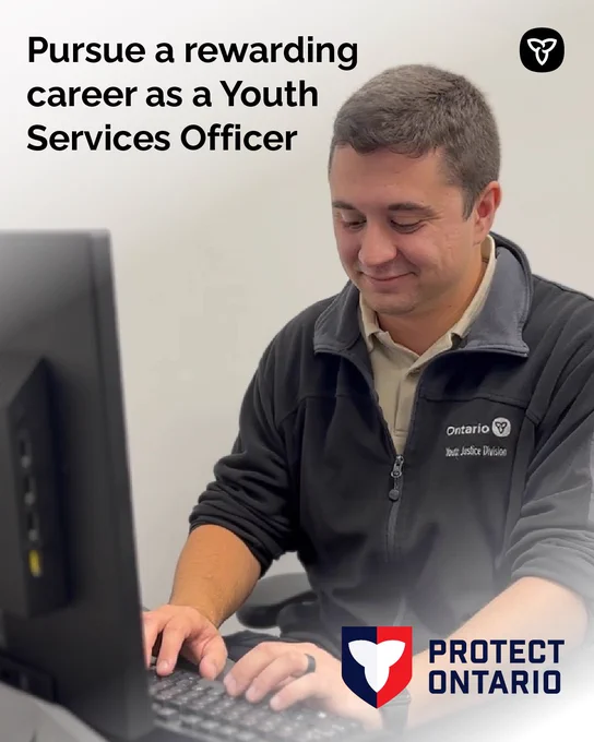 Smiling Youth Justice officer typing at a computer, promotional text for Youth Services Officer careers