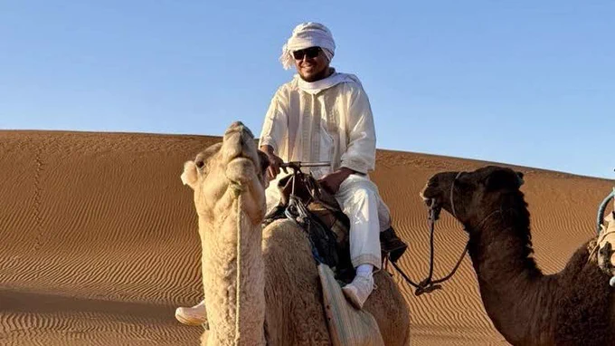 Joel Paras crossing the Sahara Dessert on a camel during a trip to Morocco.