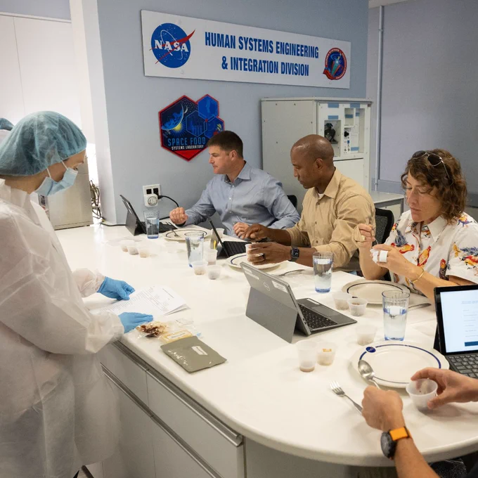 At left, NC State alumna Grace Douglas, the lead scientist for NASA’s Advanced Food Technology research, leads a food tasting session at NASA's Johnson Space Center in Houston. Artemis II crew members (from left) Canadian Space Agency astronaut Jeremy Hansen and NASA astronauts Victor Glover, Christina Koch and Reid Wiseman tasted and rated a selection of meals and snacks ahead of their trip to the Moon. (Credit: NASA)