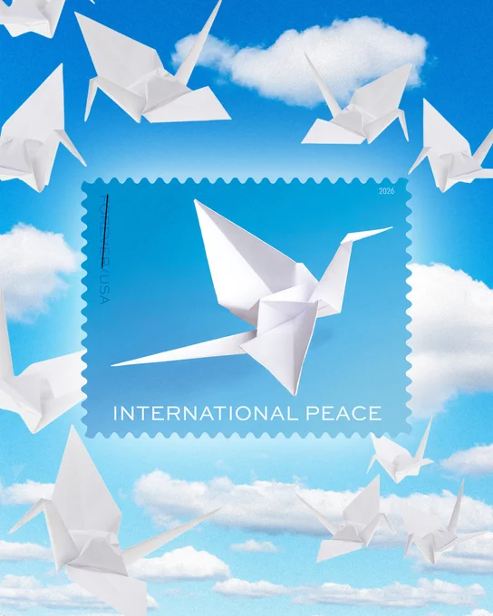 Folded paper cranes are shown in a blue sky background behind the International Peace stamp.