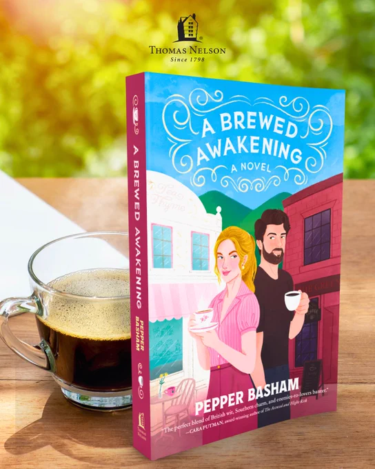 The image shows a book titled "A Brewed Awakening: A Novel" by Pepper Basham, published by Thomas Nelson. The book cover features illustrated characters holding coffee cups in front of a cafe setting. A cup of coffee is placed next to the book.
