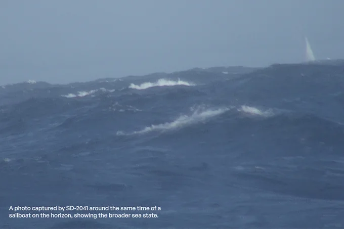 A photo captured by SD-2041 around the same time of a sailboat on the horizon, showing the broader sea state.