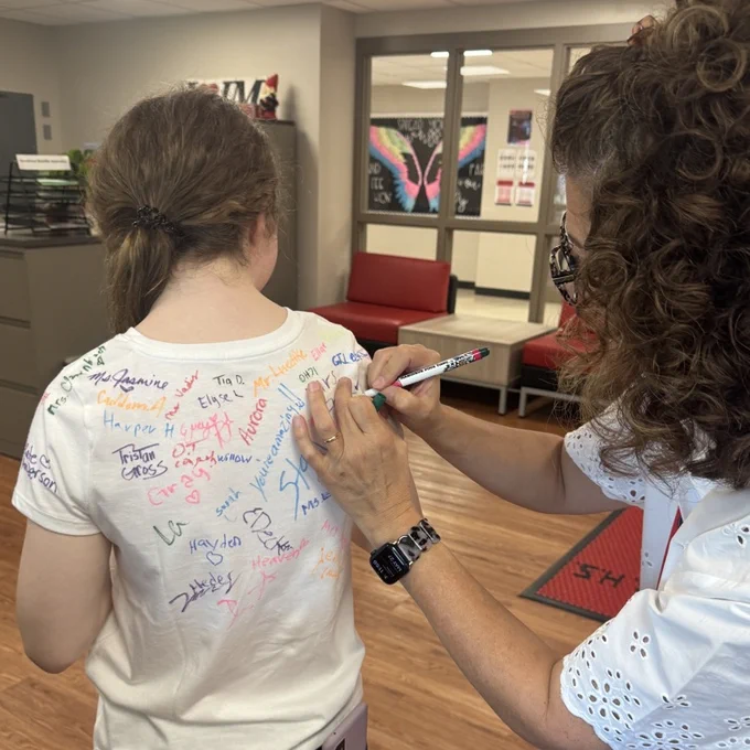 signing a senior shirt 