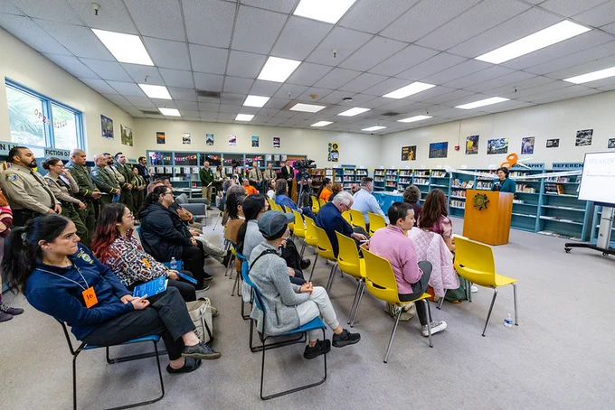 Dozens gather for the unveiling of the new men's library at Elmwood Correctional Facility.