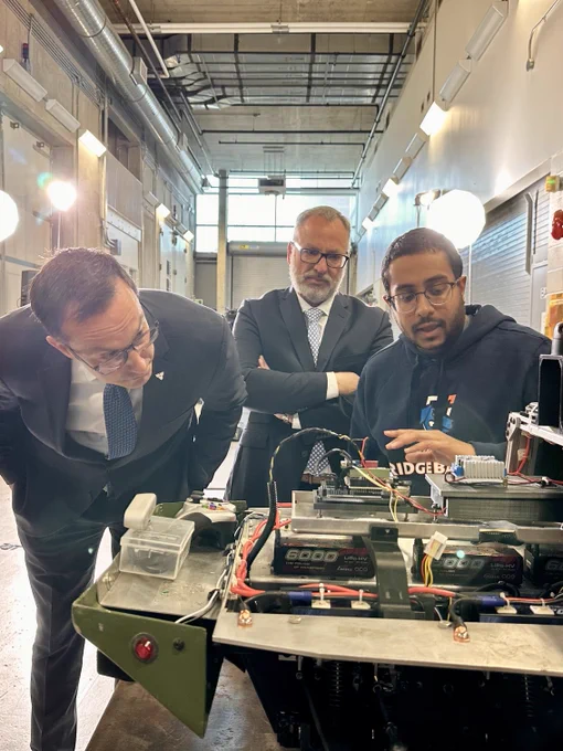 Dr. Steven Murphy, President and Vice-Chancellor of Ontario Tech University and Hon. Nolan Quinn, Minister of Colleges, Universities, Research Excellence and Security (MCURES) watch as a student presents their project inside the university's ACE facility.
