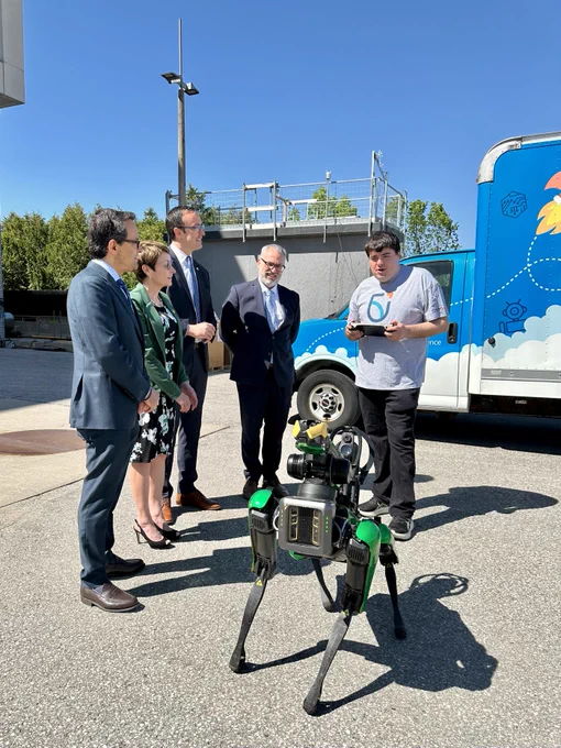 Dr. Steven Murphy, President and Vice-Chancellor of Ontario Tech University, Dr. Elaine Popp, President of Durham College, Daniel Tisch, President and CEO of the Ontario Chamber of Commerce, and Hon. Nolan Quinn, Minister of Colleges, Universities, Research Excellence and Security (MCURES) watch an Ontario Tech student demonstrate a piece of robotic technology outside the university's ACE facility.
