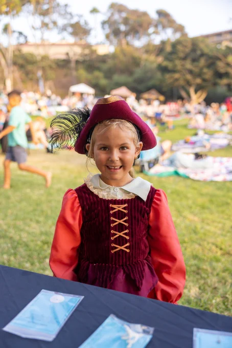 A child smiling in a pirate costume.
