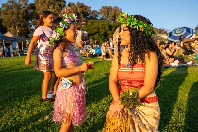 A child speaking with smiling with a character from Moana.