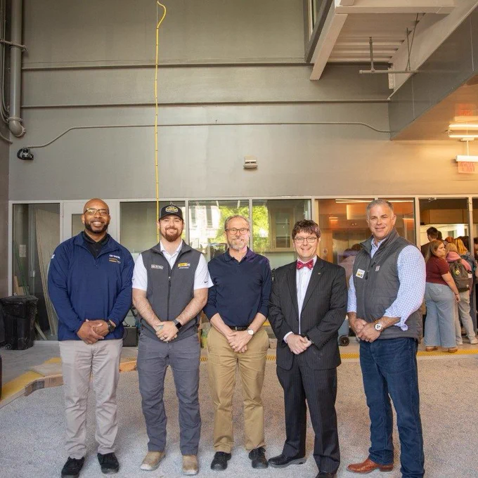 Executive Vice President Craig Kahoun (at far right) and other members of the Carter Machinery team celebrate a kickoff event in the Center for Autonomous Mining with Professor Erik Westman (third from left) and Professor Aaron Noble, head of the Department of Mining and Minerals Engineering (fourth from left).