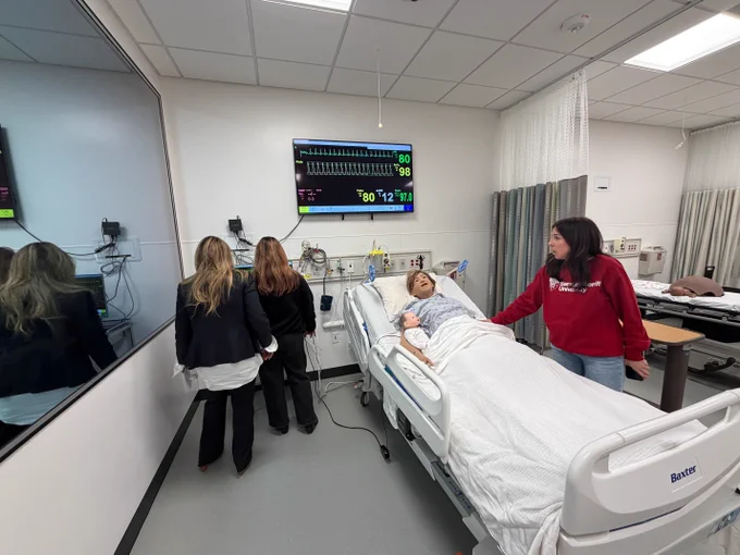 Setup of a hospital bed with a mannequin to help students train and simulate real life clinical settings. 