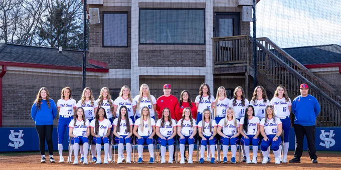 The Vol State softball team poses for a team photo on a field.