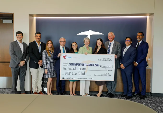 Attorneys from the Kemp Smith Law Firm smile while holding a giant check with UTEP President Heather Wilson. The check is in the amount of $100,000 for UTEP's Law School