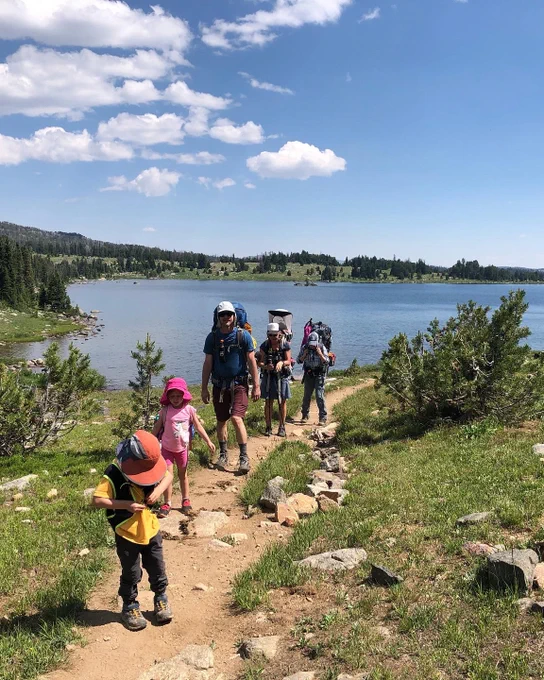 Family hiking in front of lake. 