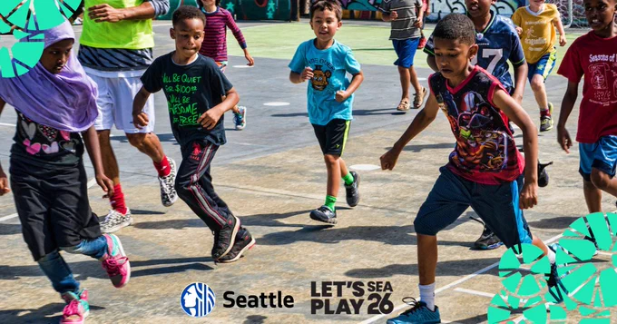 A group of children running and playing energetically on an outdoor basketball court during a community event.