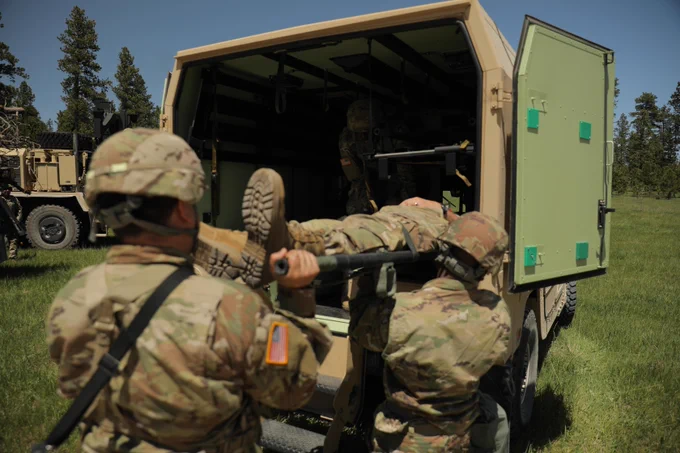 Soldiers with 1245th Transportation Company, Oklahoma Army National Guard load a wounded Soldier into a M997A3 Tactical HUMVEE Ambulance during the Combat Life Saving training lane in support of the Golden Coyote Training Exercise at Camp Rapid, South Dakota, June 13, 2022. Golden Coyote is a three-phase scenario driven exercise conducted in the Black Hills of South Dakota and Wyoming, which enables Commanders to focus on mission essentials warrior tasks and drills. (U.S. Army Photo by Pfc. Miguel Franco)