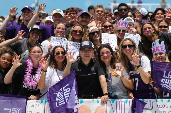 President-elect Mung Chiang joins the Northwestern student section to cheer on the Wildcats during the Lacrosse NCAA Championship. The group poses with the Wildcat claw.