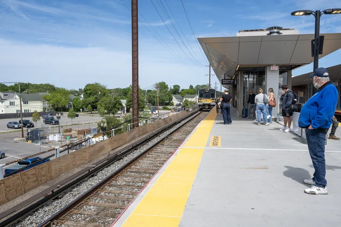 Riders waiting to board a train at Babylon Station. 