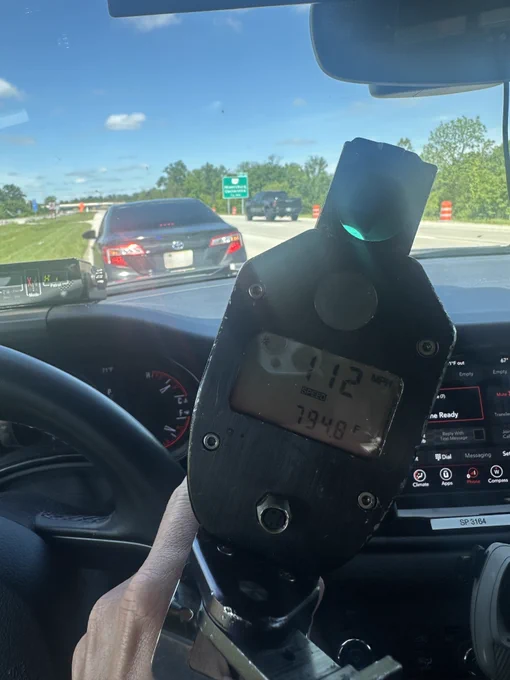 A radar, on a Patrol car dashboard, shows 112 mph. 