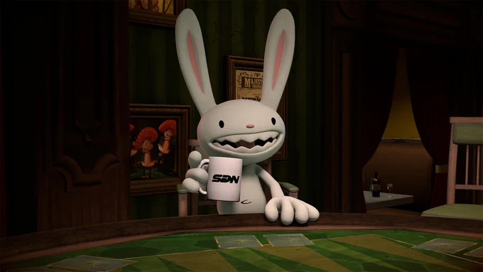 Max, the sociopathic lagomorph from Sam & Max, sitting at a poker table with a mug in his hand and a grin on his face. The mug is white with a black SDN logo on it.