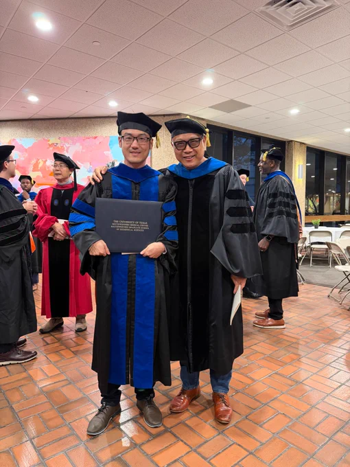 A graduate with a faculty member.