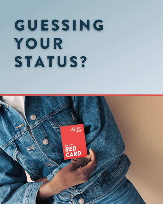 A person in a denim jacket holds a red card with the text "Give it the Red Card" and "Jackson County Public Health" logo. The top of the image has the text "Guessing Your Status?" on a blue gradient background.