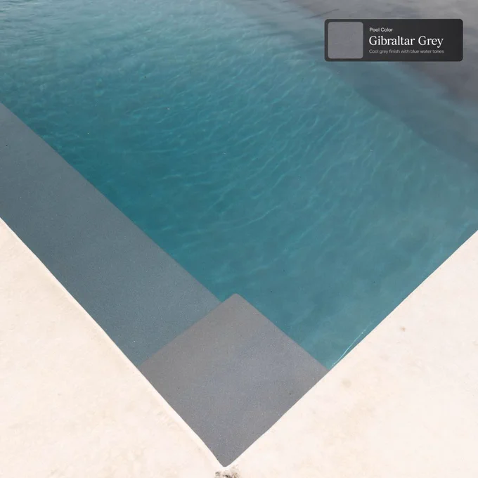 Close-up of Gibraltar Grey pool water, corner steps, and light concrete decking on an Ovation 30 fiberglass pool.