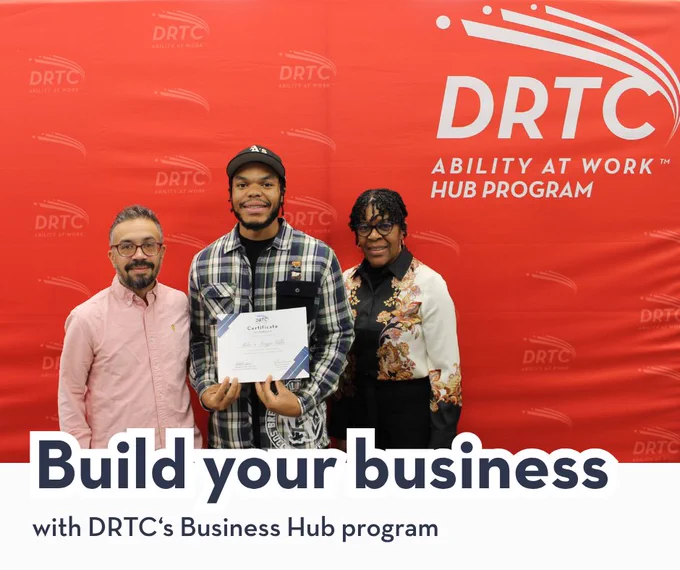 Three individuals standing in front of a red DRTC Ability at Work Hub Program backdrop, one holding a certificate.