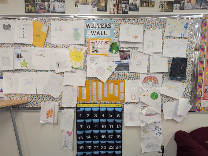 8th grade english students posting their haikus on the writers wall
