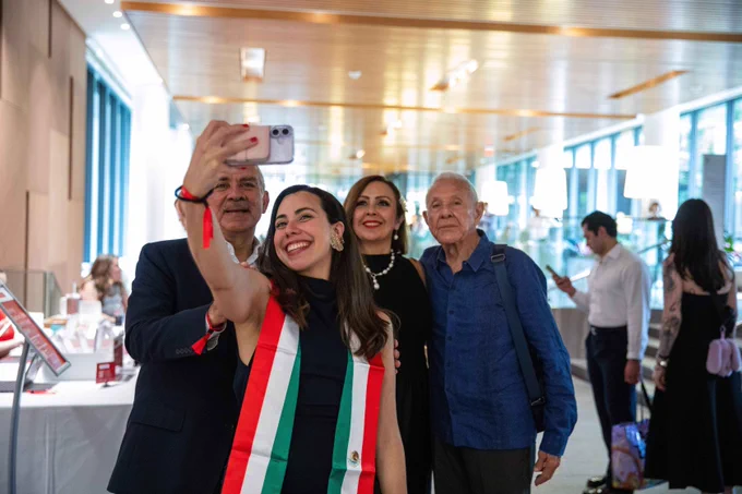 A graduate and her family taking a selfie.