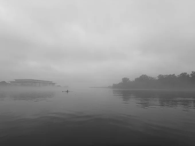 Foggy view of Washington Harbor with rower in distance