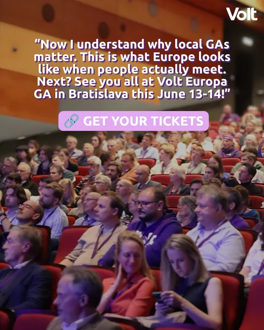A wide shot of a seated audience in a theater, with many people looking toward the stage. Overlaid text reads: "Now I understand why local GAs matter. This is what Europe looks like when people actually meet. Next? See you all at Volt Europa GA in Bratislava this June 13-14!" A purple button at the bottom says "GET YOUR TICKETS."