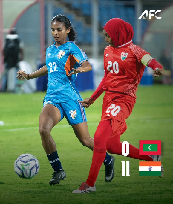 A dynamic moment from a women's soccer match with players from India and Maldives competing. The score indicates India's significant lead.