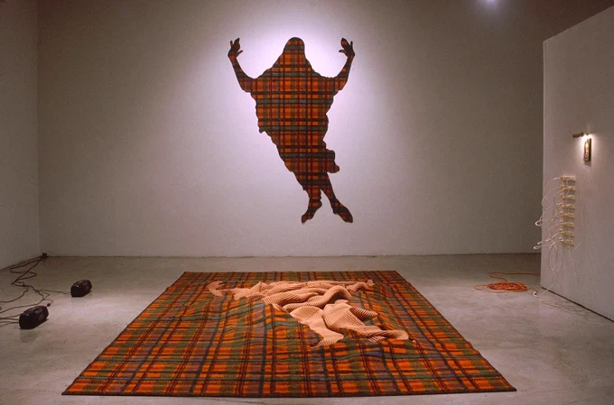 Lynn Aldrich, Grid Buster, 1989, Installation of carpet, carpet padding, stereo arrangement of Gregorian Chant and vacuum cleaner noise, framed Grunewald reproduction, picture light, surge protectors, 120 x 204 in (304.8 x 518.2 cm), L.ALD-2. Courtesy of Royale Projects 