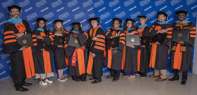 President Helldobler (center) with the graduates who earned a doctorate in educational leadership.