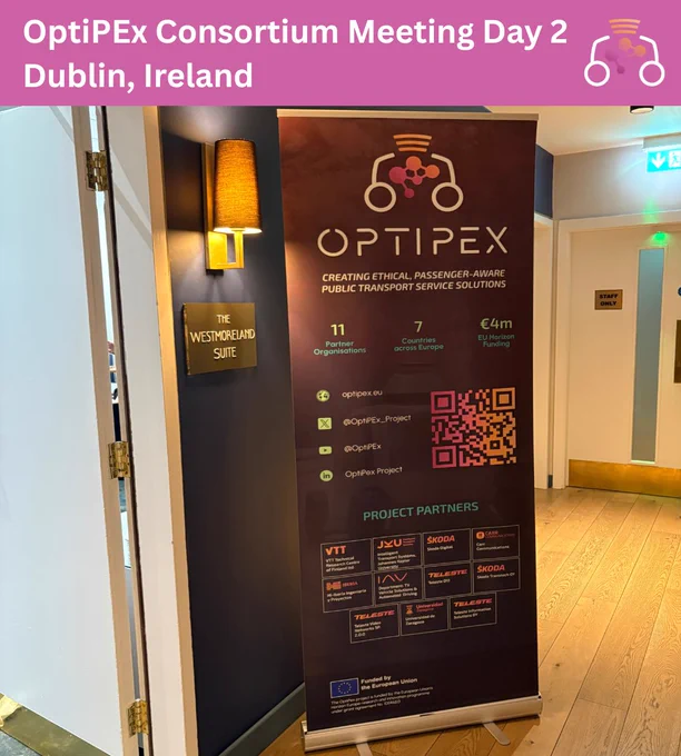 Image shows a banner for the OptiPEx Project. The banner is beside a door in a hallway.