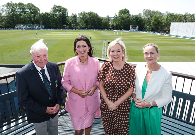 Image of four people at the Ireland v New Zealand Test match - First Minister Michelle O’Neill and deputy First Minister Emma Little-Pengelly with Cricket Ireland CEO Sarah Keane and President Bryan O'Donnell.