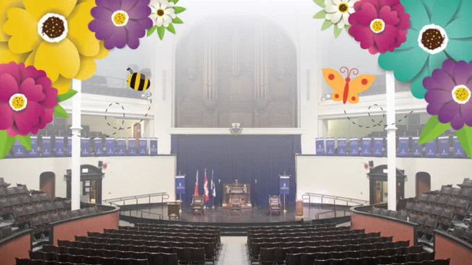 Inside empty convocation hall with banners.

