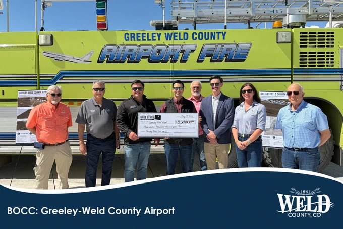 Weld County Commissioner Kevin Ross, U.S. Congressman Gabe Evans, Greeley Mayor Dale Hall, Airport Director Cooper Anderson, and members of the Greeley-Weld County Airport Authority posing with a check awarded to the airport.