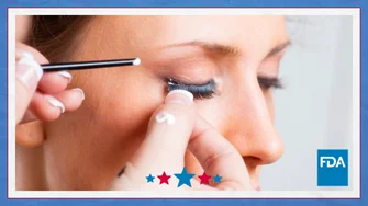 Image of a woman getting her eyelashes attached.
